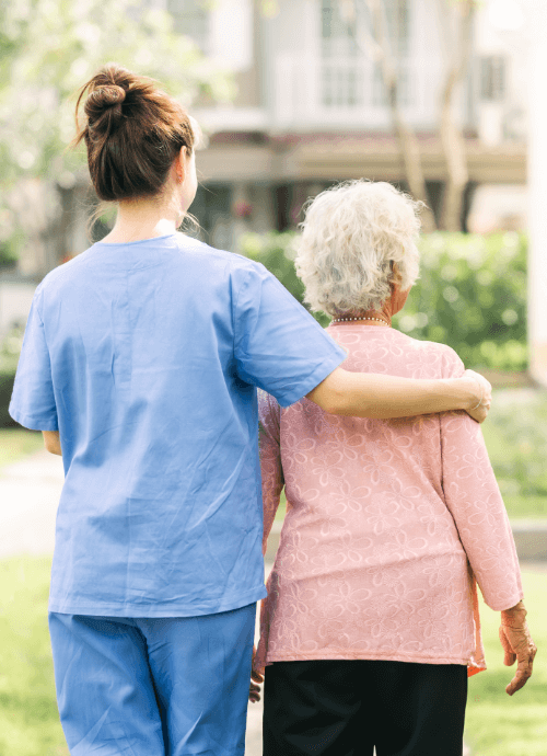 caregiver walking with elderly woman outdoor